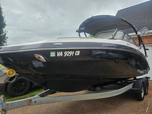 Yamaha Boats 242 Limited S 2012 Yamaha Boats 242 Limited S on trailer, black hull, parked in driveway.