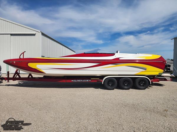 Eliminator Daytona 30 2005 Eliminator Daytona 30 speedboat with vibrant red, yellow, and white design on a trailer.