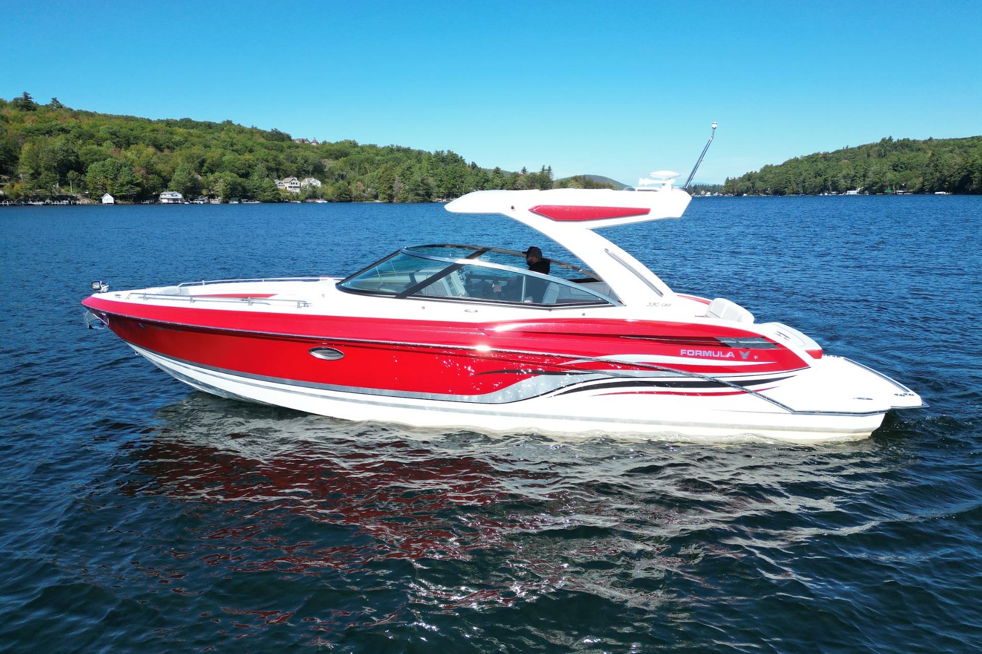Formula 330 Crossover Bowrider 2024 Formula 330 Crossover Bowrider in vibrant red on a serene lake.