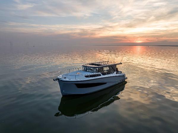 Delphia D10 Sedan 2025 Delphia D10 Sedan yacht on calm water at sunset.