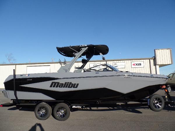 Malibu 25 LSV 2025 Malibu 25 LSV boat on trailer, sleek design, gray and black color scheme.