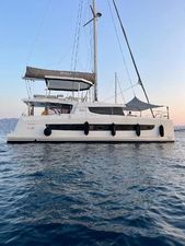 Bali 4.8 2021 Bali 4.8 catamaran sailing on calm waters at sunset.