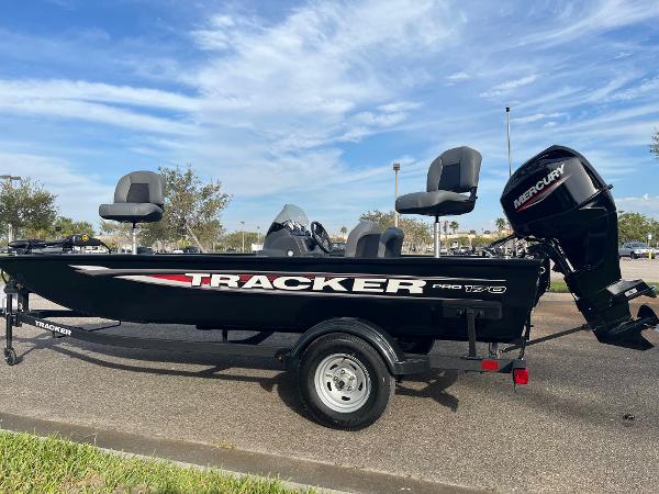 Tracker Pro 170 2025 Tracker Pro 170 boat with Mercury engine on a trailer, parked outdoors.