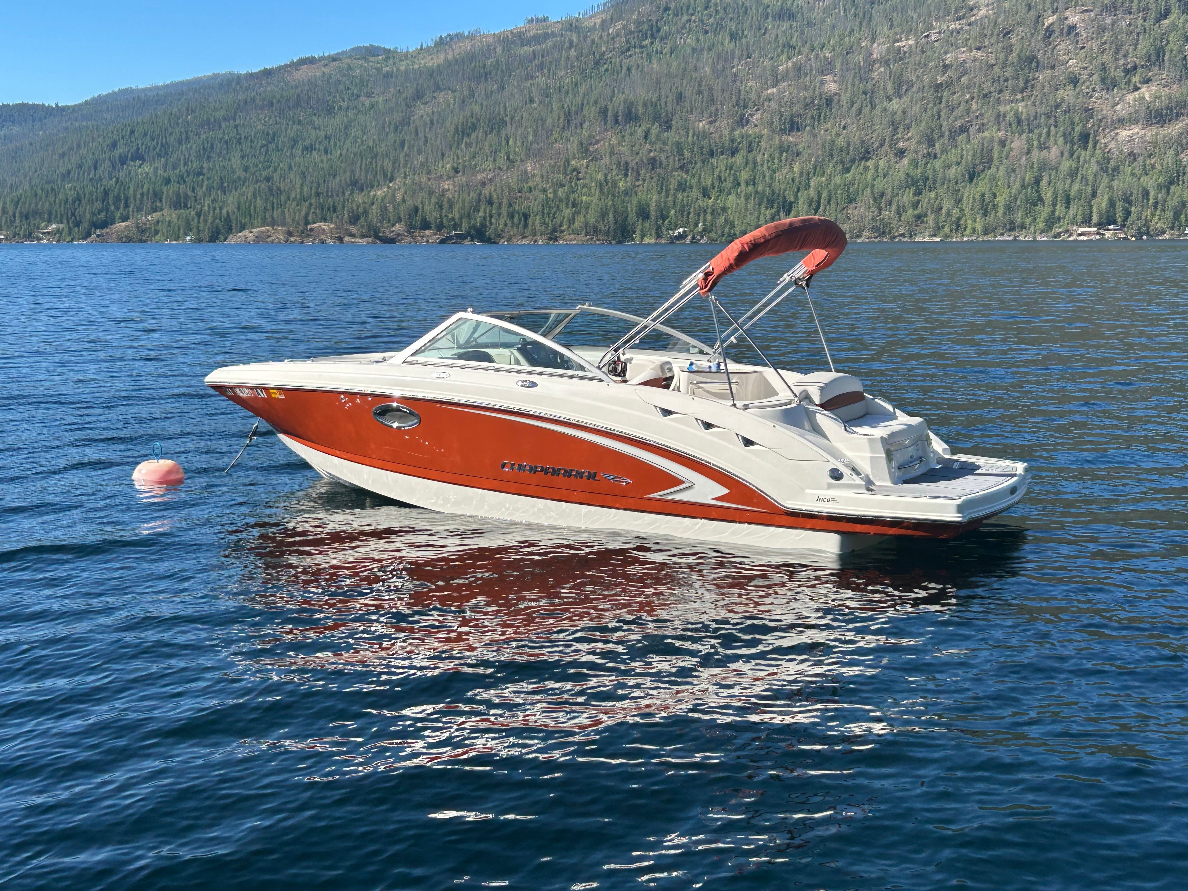 Chaparral 224 Sunesta 2008 Chaparral 224 Sunesta boat on a serene lake with forested hills.