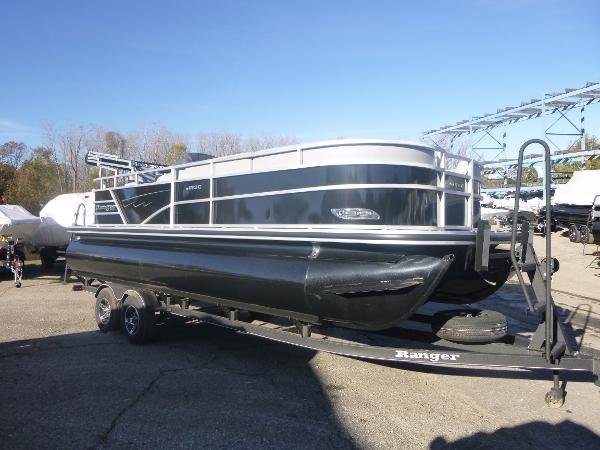 Ranger Reata 223C 2024 Ranger Reata 223C pontoon boat on trailer, parked outdoors.
