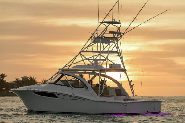 Mag Bay 42 Express 2025 Mag Bay 42 Express boat at sunset on the water.