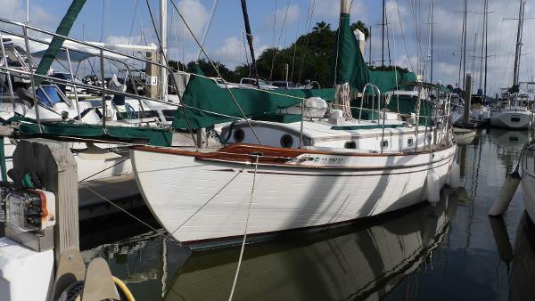 Tayana 37 1979 Tayana 37 sailboat docked at marina under clear skies.