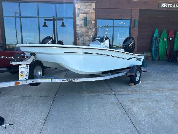 Mako Pro Skiff 15 CC 2024 Mako Pro Skiff 15 CC on trailer outside a store.