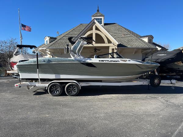 Centurion Fe25 2025 Centurion Fe25 boat on trailer, parked in front of a house with American flag.