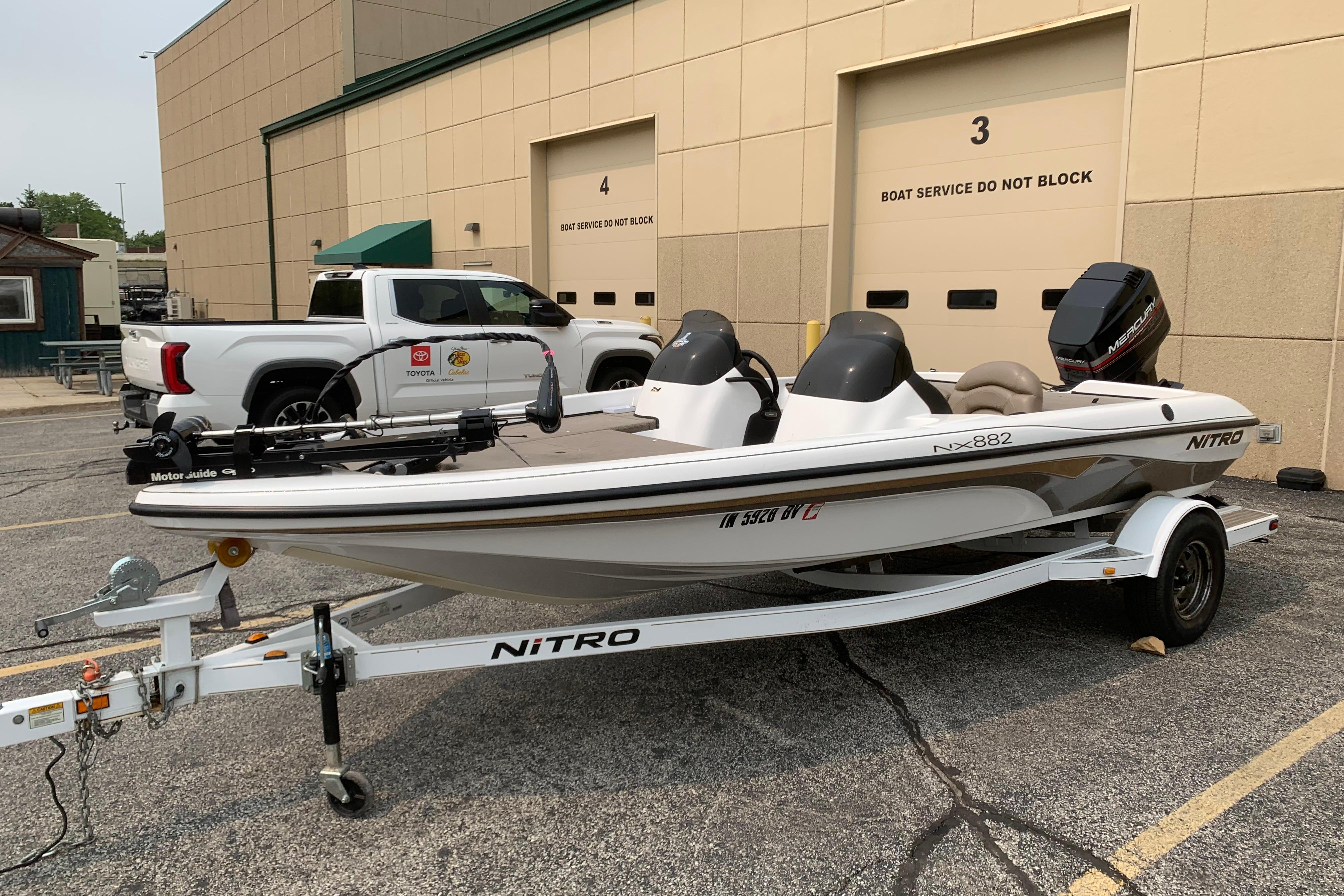 Nitro NX 882 DC 2002 Nitro NX 882 DC boat on trailer, parked near service garage.