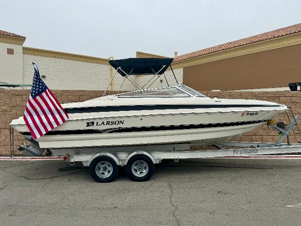 Larson LXi 248 2006 Larson LXi 248 boat on trailer with American flag.