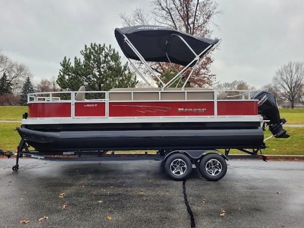 Ranger Reata 200F 2024 Ranger Reata 200F pontoon boat with canopy on a trailer, parked outdoors.