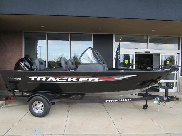 Tracker Pro Guide V-16 WT 2025 Tracker Pro Guide V-16 WT boat on display outside a building.