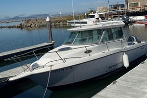 Seaswirl Striper 26 2003 Seaswirl Striper 26 boat docked at marina, calm water, clear sky.
