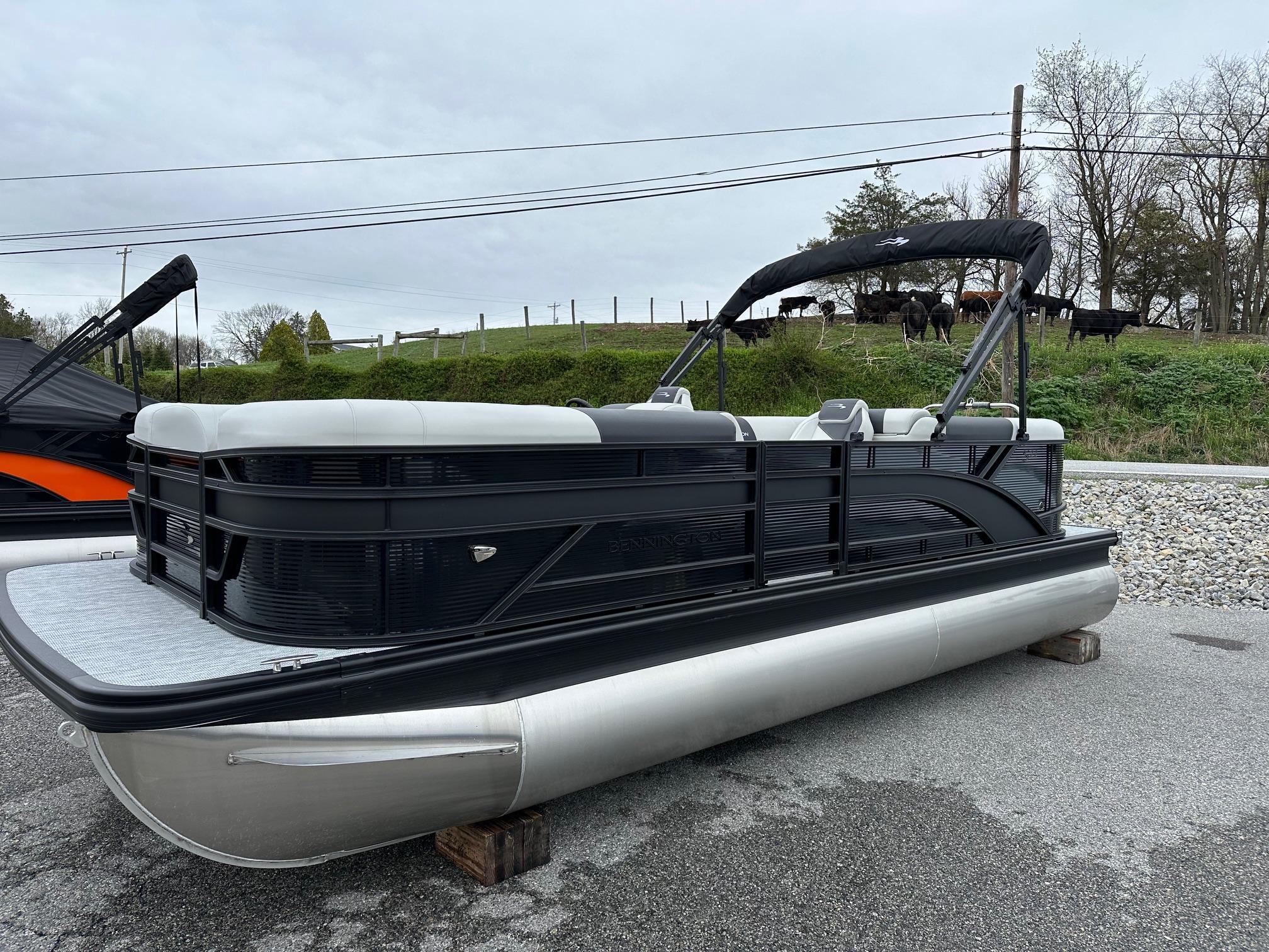 Bennington 22 SSR Quad Bench Tritoon with Yamaha F-150HP (In Stock) 2025 Bennington 22 SSR Quad Bench Tritoon with Yamaha F-150HP, displayed outdoors.