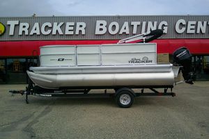 Sun Tracker Party Barge 16 DLX 2026 Sun Tracker Party Barge 16 DLX pontoon boat on trailer at dealership.