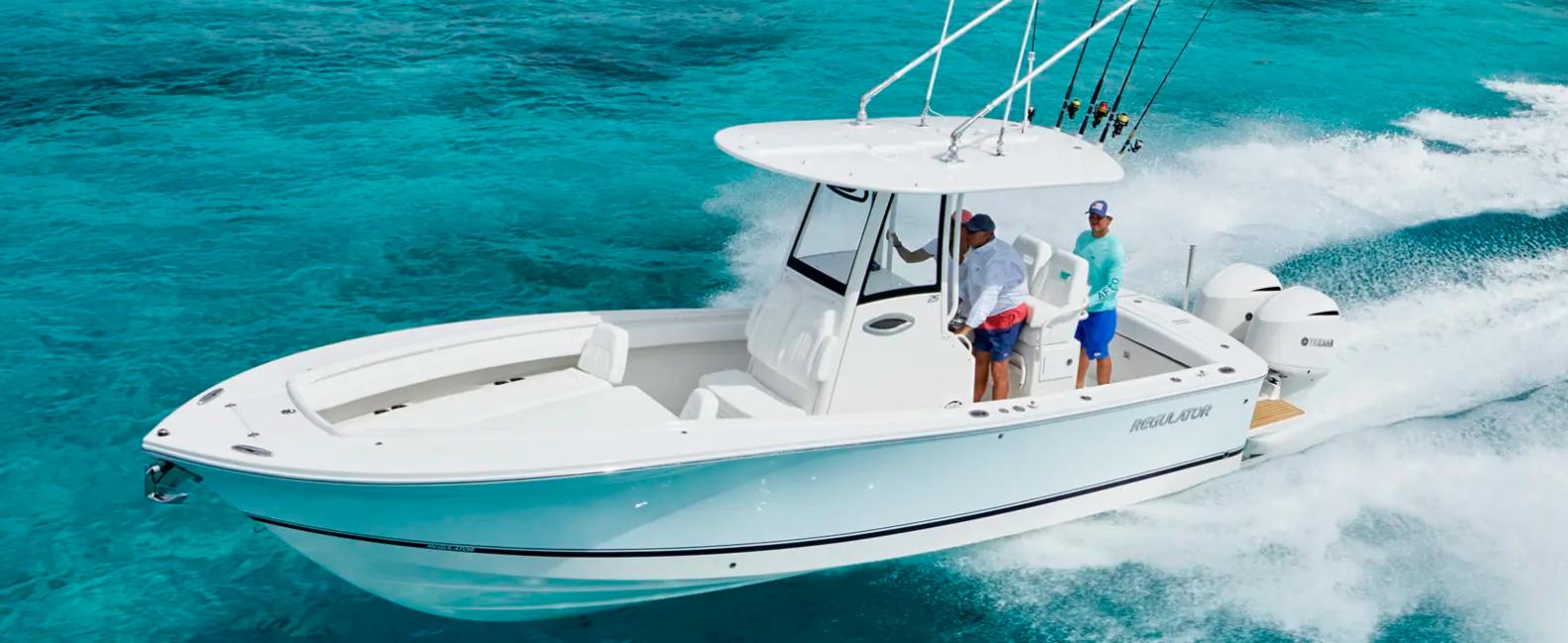 Regulator 25 2026 Regulator 25 boat cruising on clear turquoise water, featuring fishing rods and dual engines.