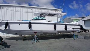 Axopar 37 2024 Axopar 37 boat on stands, white exterior, docked at a marina.