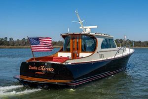 Hinckley Talaria 44 MY 2006 Hinckley Talaria 44 MY yacht cruising with American flag on water.