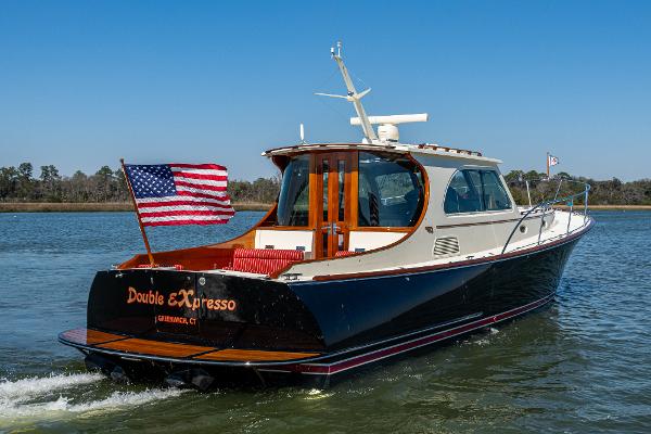 Hinckley Talaria 44 MY 2006 Hinckley Talaria 44 MY yacht cruising with American flag on water.