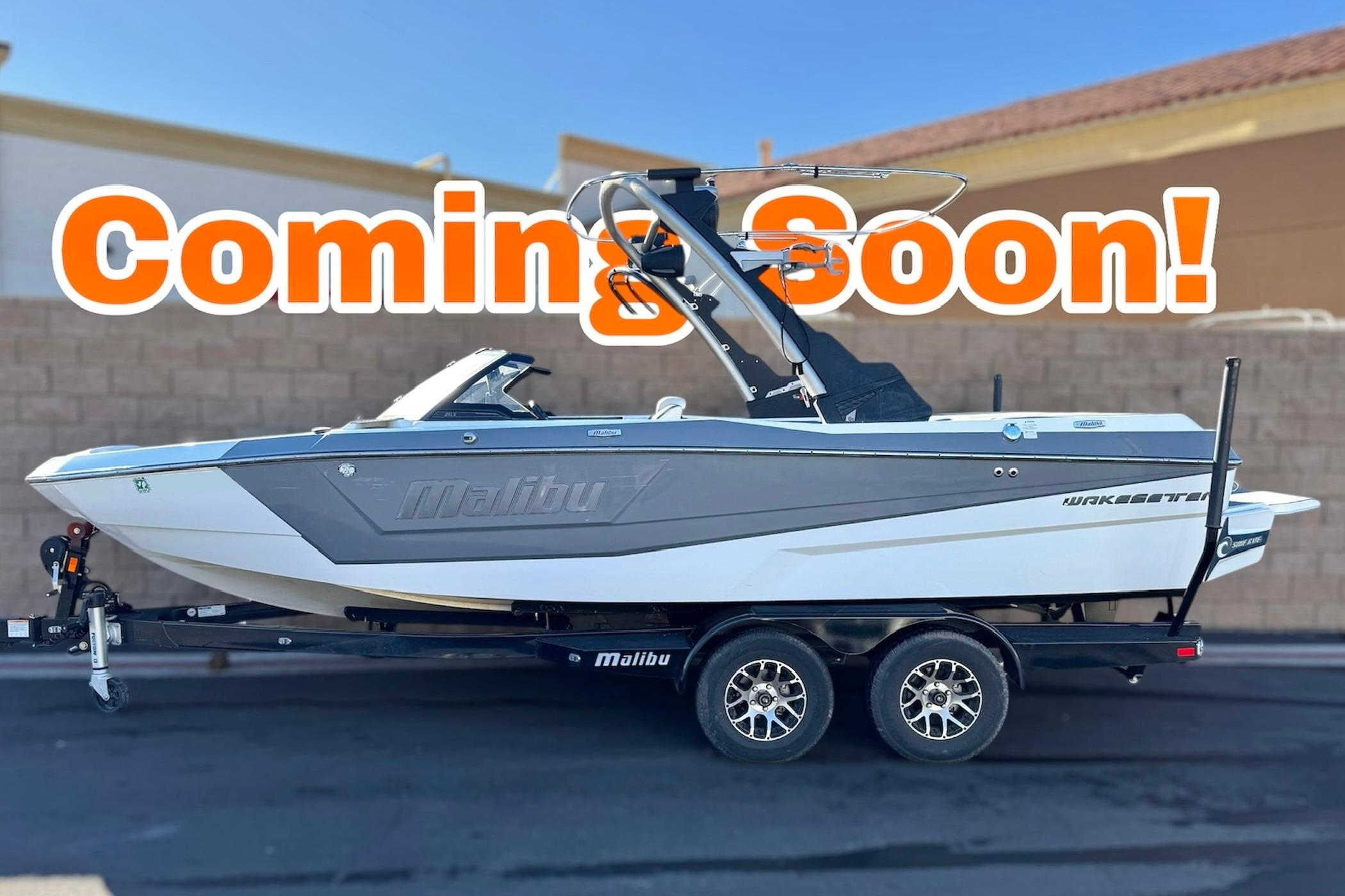 Malibu Wakesetter 21 LX 2023 Malibu Wakesetter 21 LX boat on trailer, "Coming Soon" text overlay.