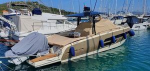 Invictus GT 370S 2021 Invictus GT 370S yacht docked in marina, covered with beige tarpaulin.