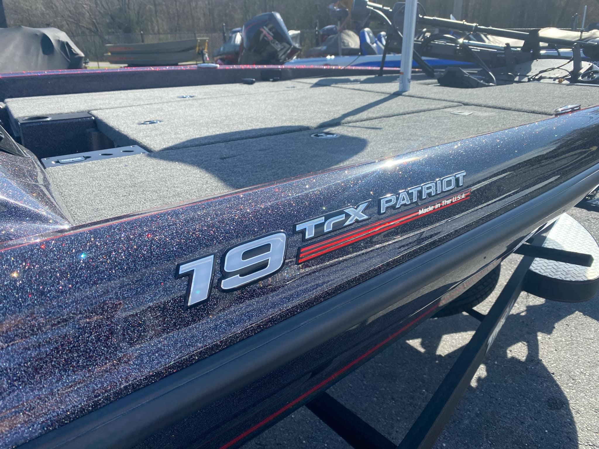 Triton 19 TrX Patriot 2025 Triton 19 TrX Patriot boat with glitter finish, parked outdoors.