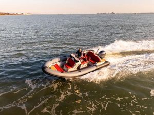 Ribeye A683 Ribeye A683 boat cruising on open water, 2022 model, with a person steering.
