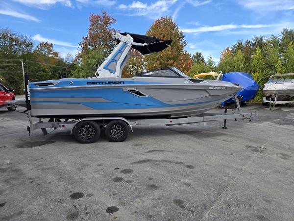 Centurion Ri230 2023 Centurion Ri230 boat on trailer, blue and gray, parked outdoors.