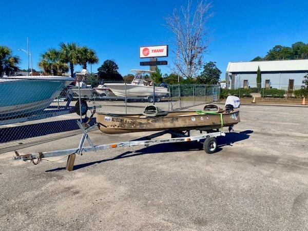 Gheenoe 13' 1999 Gheenoe 13' boat on trailer in parking lot, sunny day.