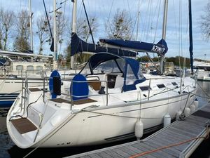 Dufour 385 Grand Large 2007 Dufour 385 Grand Large sailboat docked at marina, featuring blue accents and spacious deck.