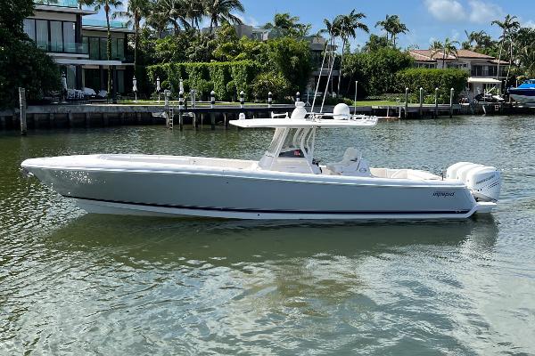 Intrepid 375 Center Console 2015 Intrepid 375 Center Console boat on calm water, surrounded by lush greenery.