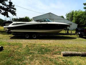 Sea Ray 270 SLX 2005 Sea Ray 270 SLX boat on trailer, parked outdoors near a building.
