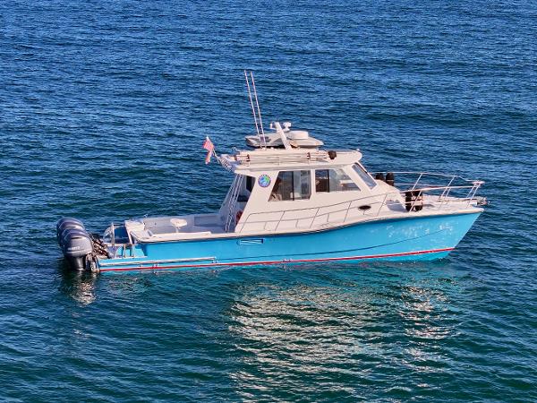 Custom Power Catamaran Custom 2005 P-38 Lightning Power Catamaran on blue water.