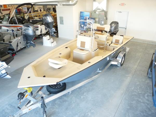 G3 Bay 19 GX 2025 G3 Bay 19 GX boat on trailer in showroom, featuring dual outboard motors.