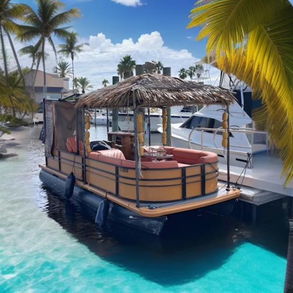 Custom Tiki bahama mama 1.0 Custom Tiki Bahama Mama 1.0 pontoon boat docked in tropical marina, 2024 model.