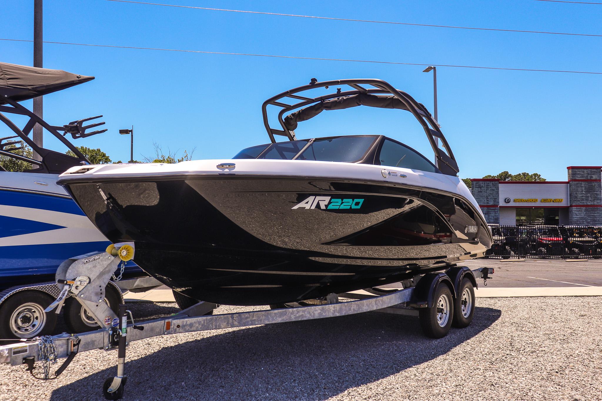 Yamaha Boats AR220 2025 Yamaha Boats AR220 on trailer, sleek black design, parked outdoors.