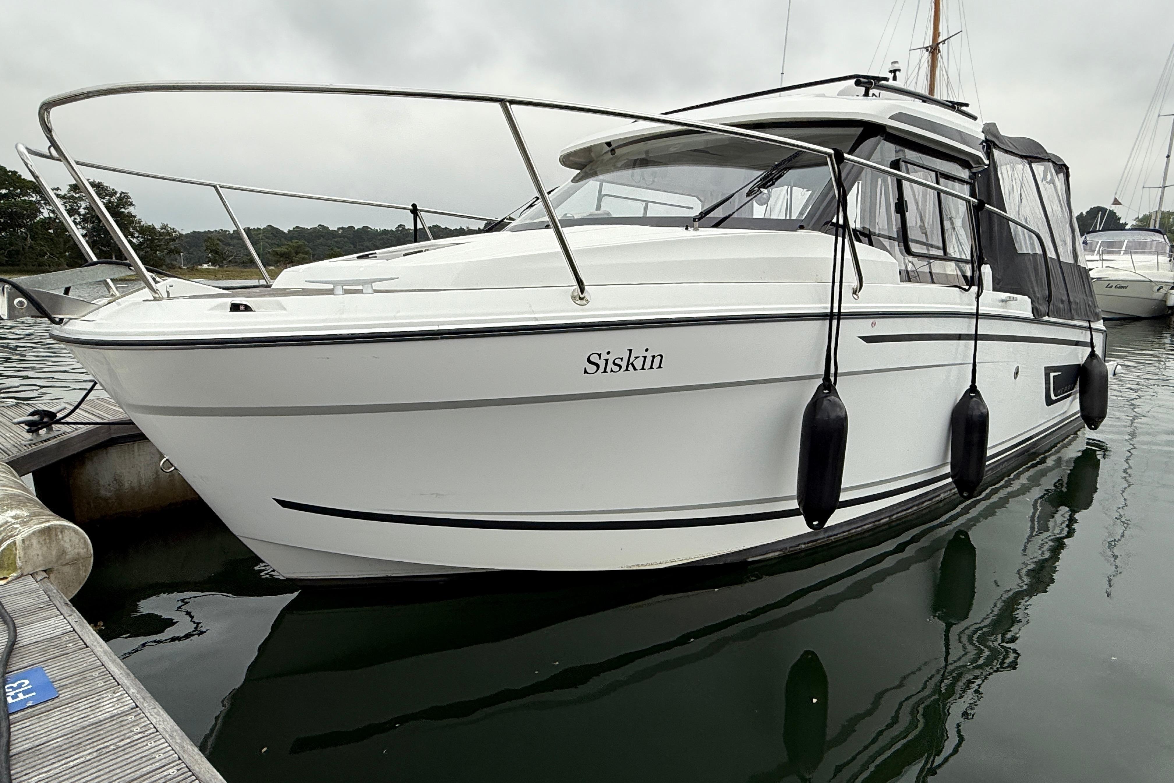 Jeanneau Merry Fisher 795 Series 2 2022 Jeanneau Merry Fisher 795 boat docked, named "Siskin," with protective fenders.