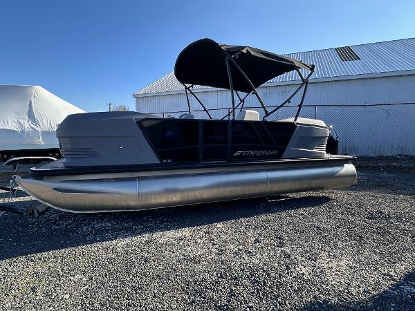 Starcraft GX 20 R DH 2025 Starcraft GX 20 R DH pontoon boat with canopy, parked outdoors.