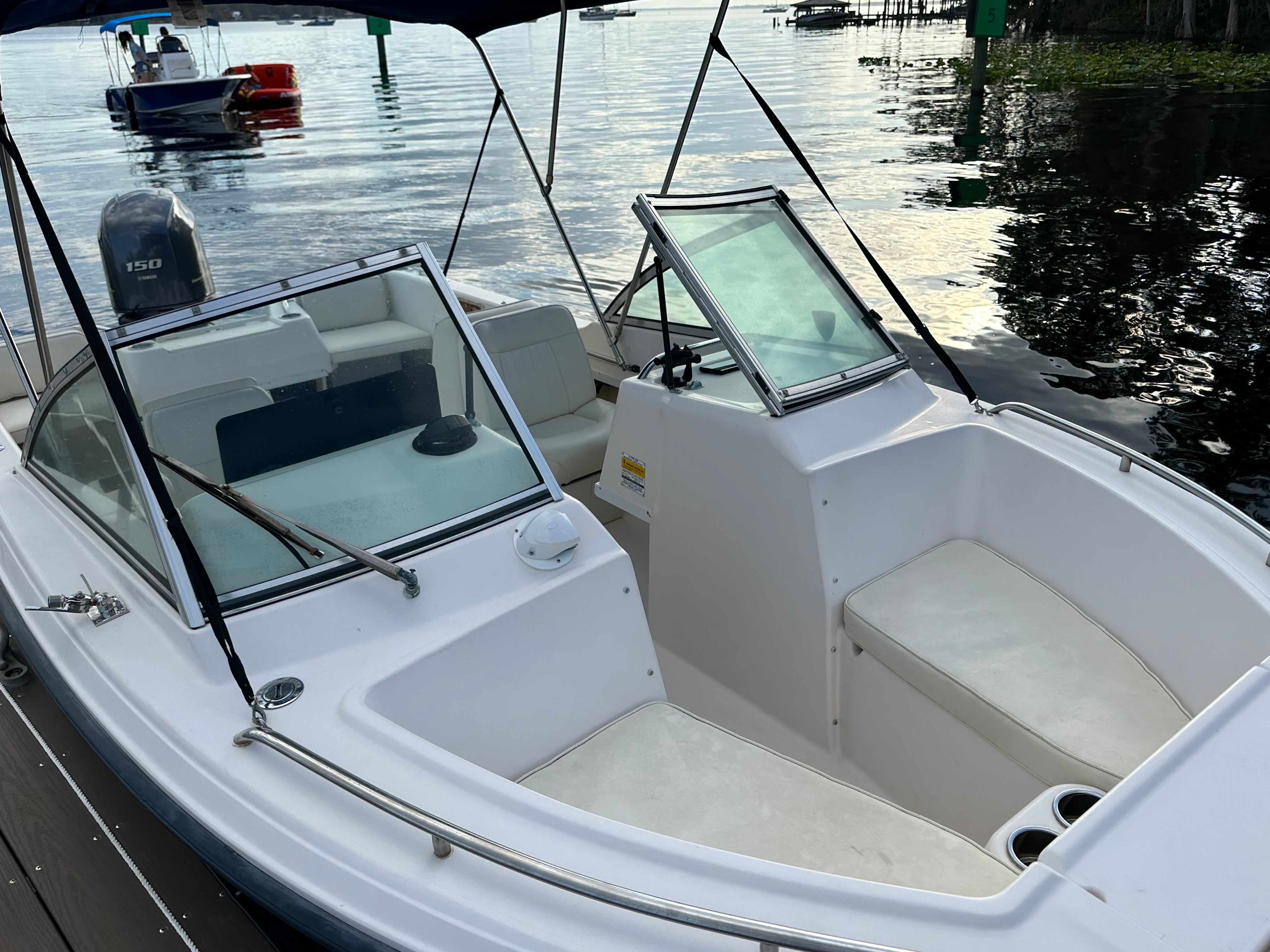 Grady-White Tournament 192 1995 Grady-White Tournament 192 boat with seating, docked on calm water.