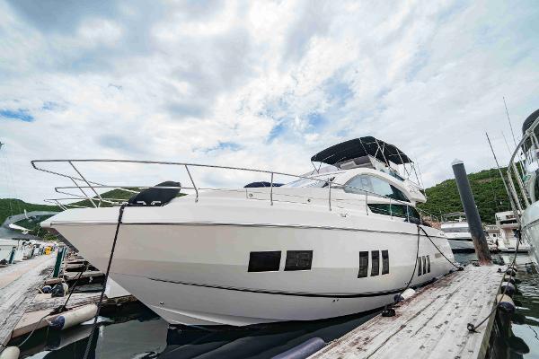Fairline Squadron 50 2015 Fairline Squadron 50 yacht docked at marina under cloudy sky.