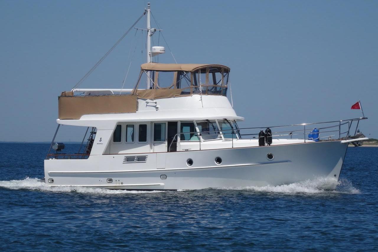 Beneteau Swift Trawler 42 2007 Beneteau Swift Trawler 42 cruising on open water under clear blue skies.
