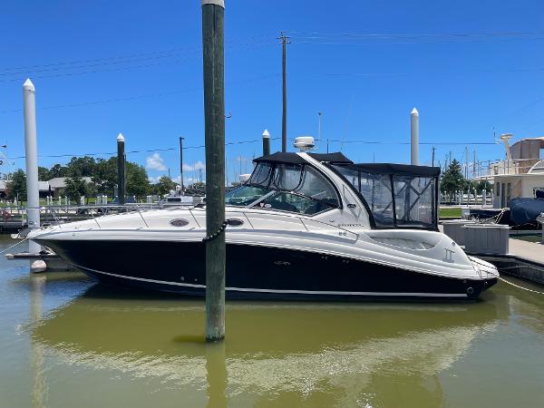 Sea Ray 340 Sundancer 2007 Sea Ray 340 Sundancer docked at marina under clear blue sky.