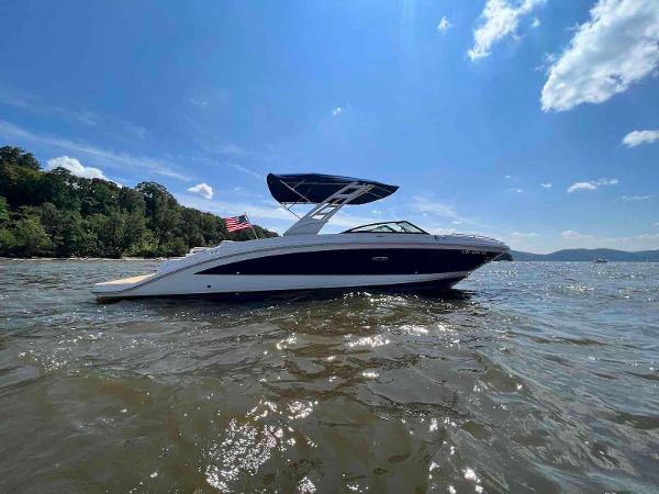 Sea Ray SDX 290 2021 Sea Ray SDX 290 boat on water under clear blue sky.