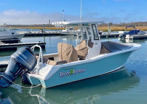 Tidewater 232 LXF 2023 Tidewater 232 LXF boat docked, featuring Yamaha outboard motor, in a marina setting.