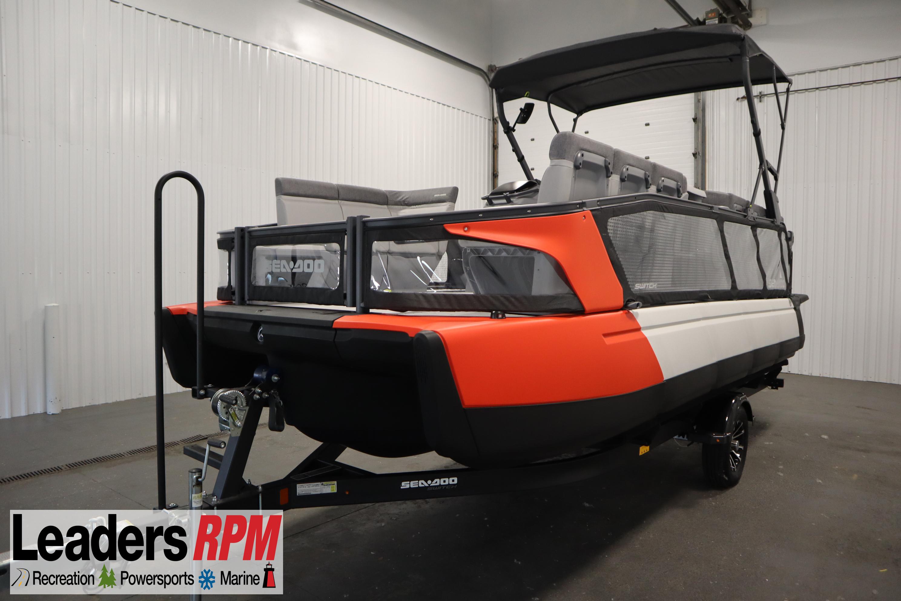 Sea-Doo Switch® 21 Sport/Cruise - 230 hp 2024 Sea-Doo Switch 21 Sport/Cruise boat, 230 hp, displayed indoors on a trailer.
