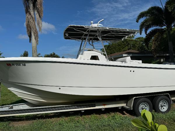 Edgewater 260 Center Console 2002 Edgewater 260 Center Console boat on trailer, parked on grass.