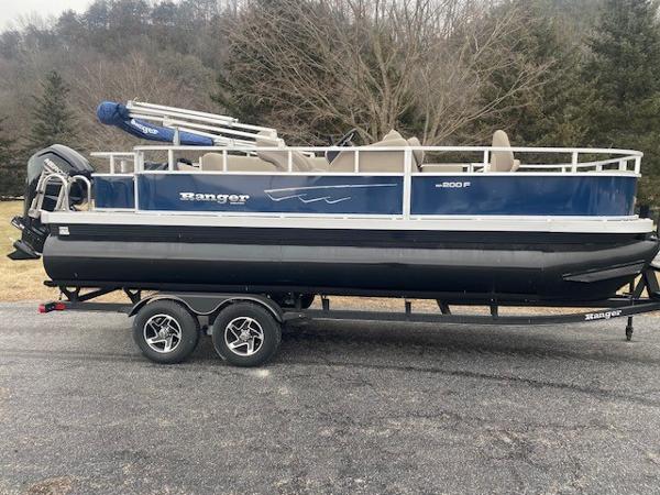 Ranger Reata 200F 2024 Ranger Reata 200F pontoon boat on trailer, parked outdoors.