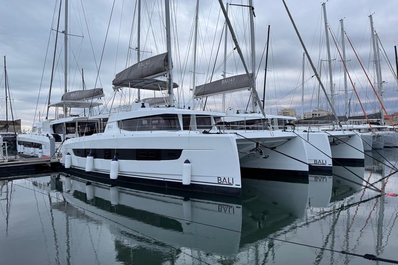 Bali 4.8 2025 Bali 4.8 catamarans docked in a marina, reflecting on calm water.