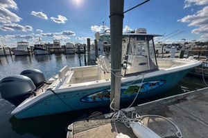 Cobia 277 Center Console 2016 Cobia 277 Center Console boat docked at marina under blue sky.